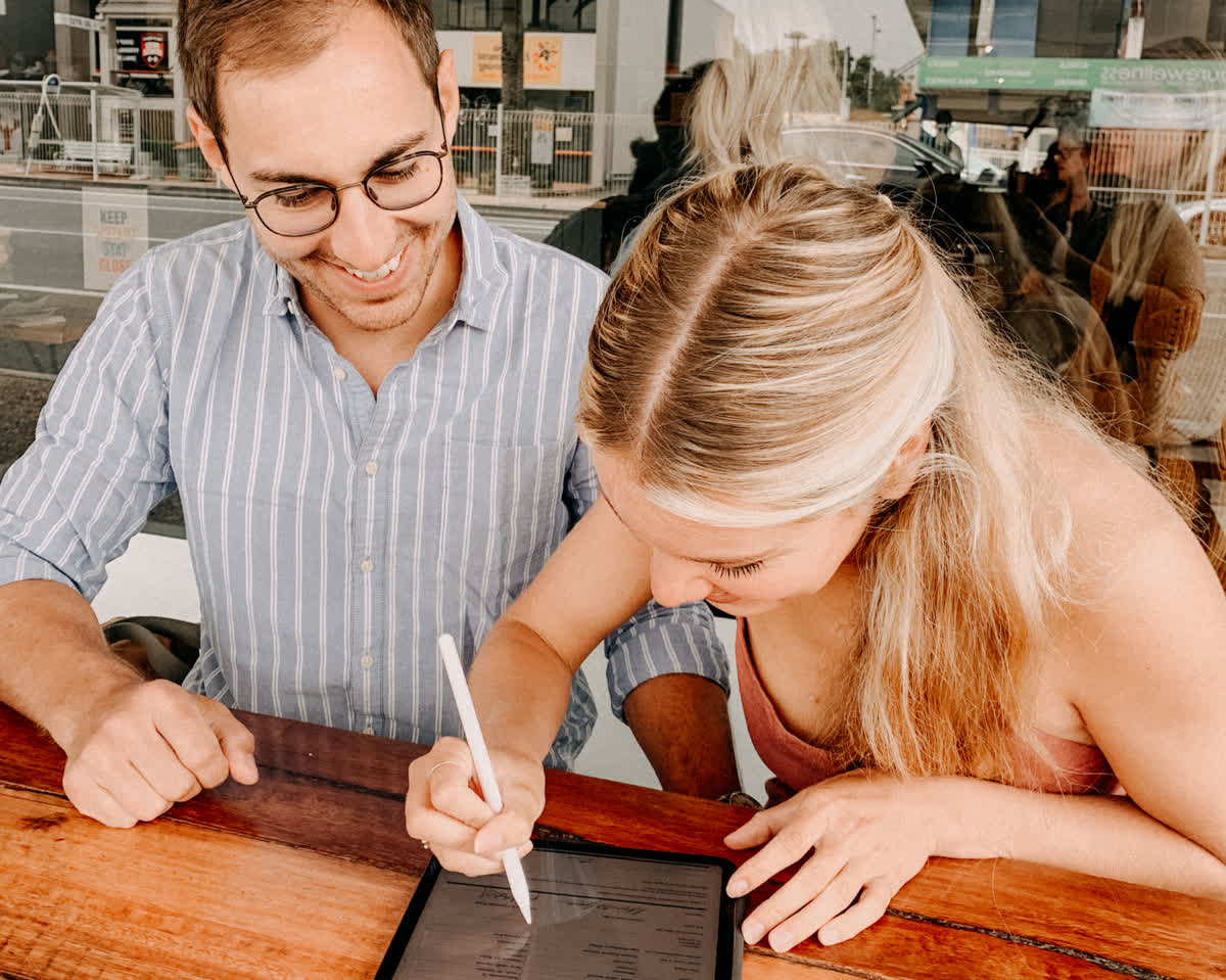 Couple signing simple wedding paperwork on the Gold Coast